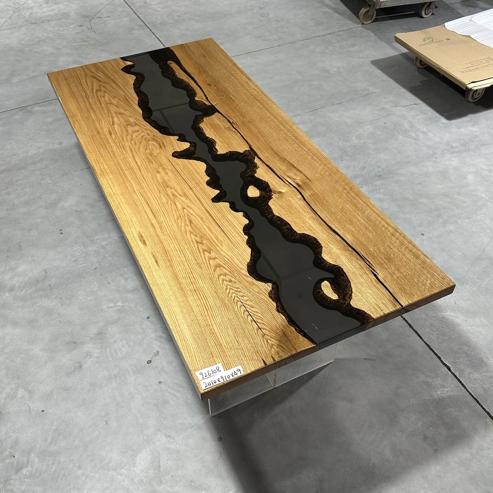 Angled full view of ET0004 wood epoxy table top with small wood islands in the black river